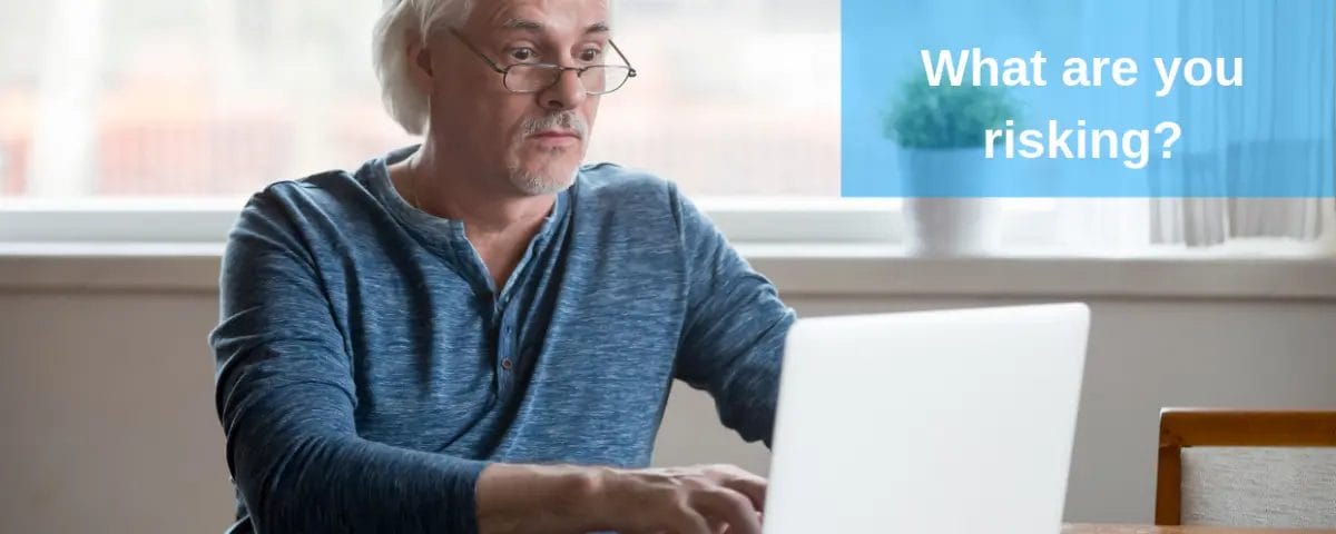 older man typing on laptop