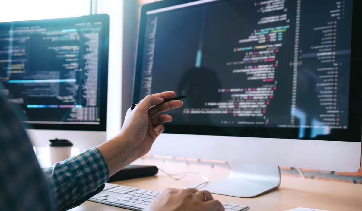 man lookin at a programming code on monitor